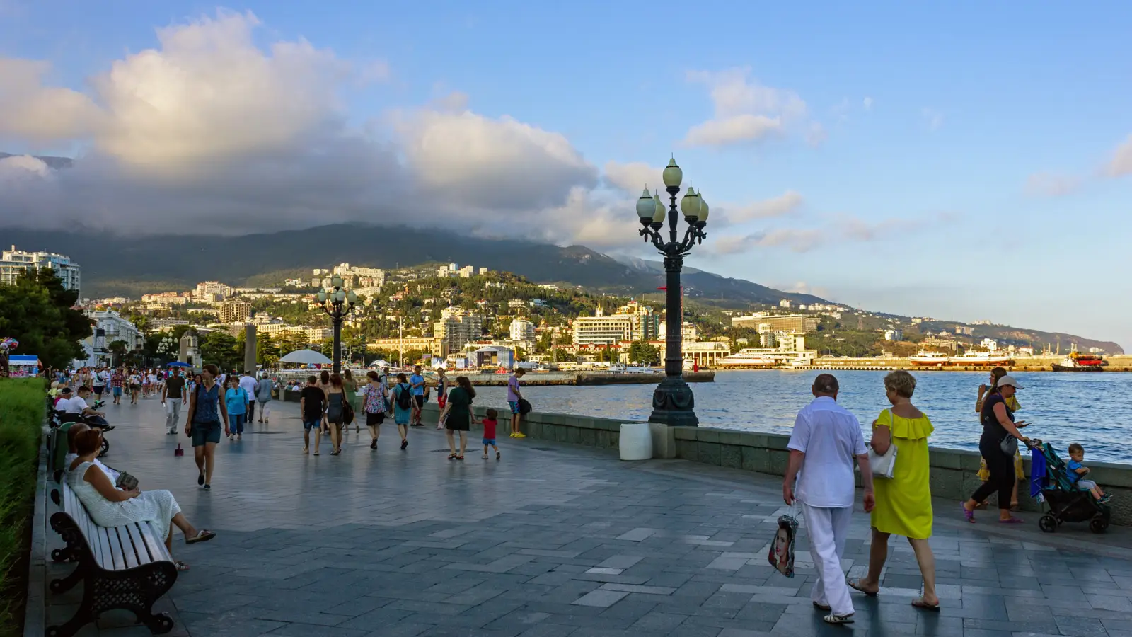 Широкая плиточная набережная Ленина в Ялте, ровная, без ступенек, идут люди с колясками